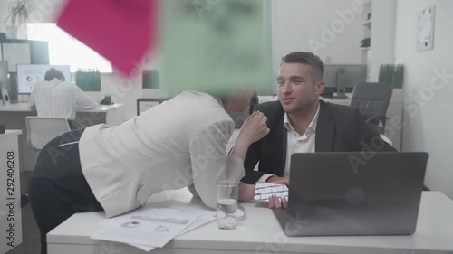 Workday at the office, collegues flirt with each other.