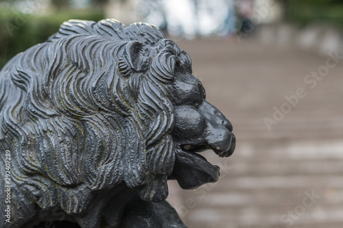 A lone metal lion somewhere in the park