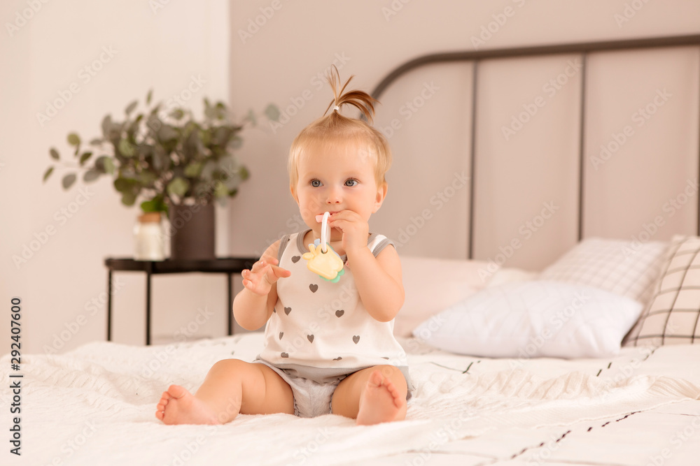 baby girl plays in a bedroom,Portrait Of Smiling Baby Girl Sitting On Bed baby girl plays in a bedroom,Portrait Of Smiling Baby Girl Sitting On Bed