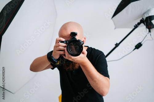 an photographer with camera in studio photo