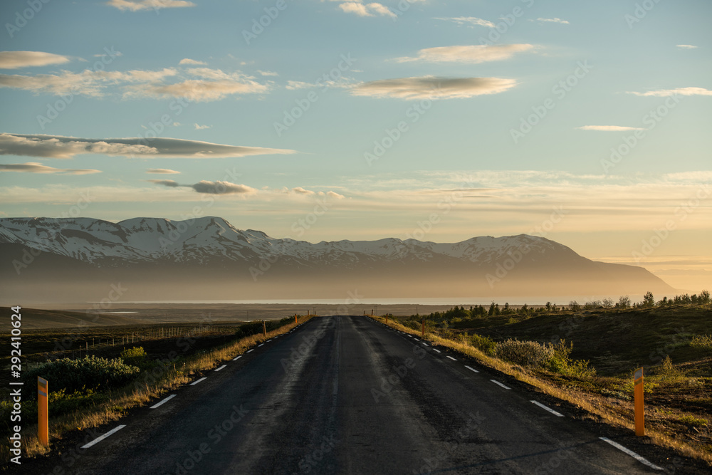 Beautiful icelandic road background leading to snowy mountains on the north of Iceland