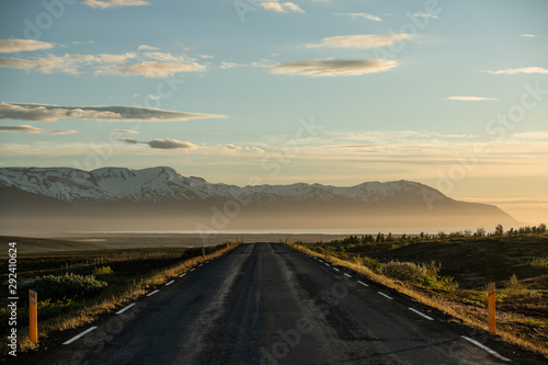 Beautiful icelandic road background leading to snowy mountains on the north of Iceland
