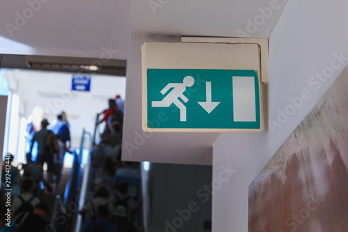 Foto Emergency exit sign in corridor mounted on a wall