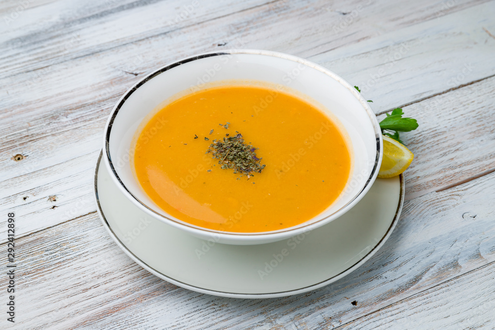 Lentil soup with lemon on wooden table. Turkish cuisine Lentil soup with lemon on wooden table. Turkish cuisine