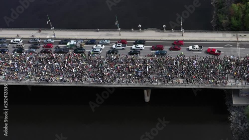 Civil unrest group of protestors crossing a bridge with signs and angry people photo