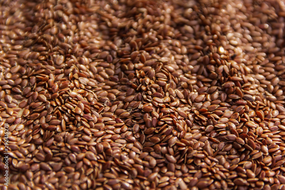 Brown flax seeds give flaxseed oil background Brown flax seeds give flaxseed oil background