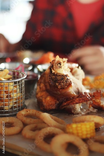 Obraz na płótnie Close up of pork knuckle with snacks on pub's table background w salonie