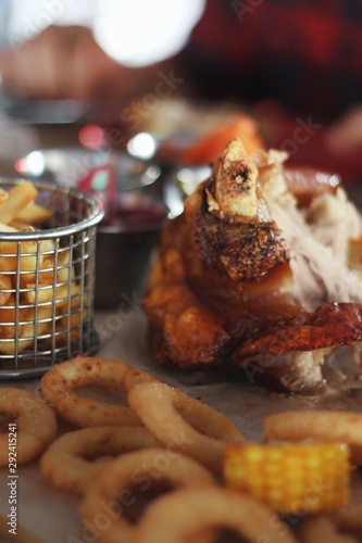 Obraz na płótnie Close up of pork knuckle with snacks on pub's table background w salonie