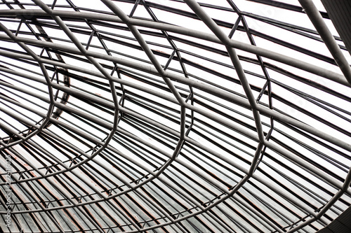 Abstract geometric shapes if a curved metal and glass ceiling of a concert opera house / event space 