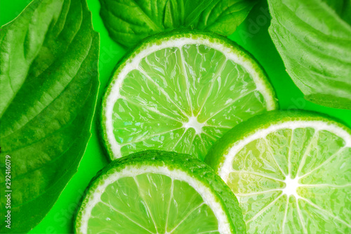 Lime with green leafs on a green background