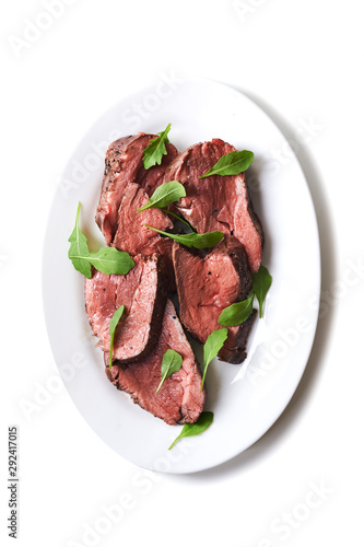 plate with sliced medium rare roast beef 