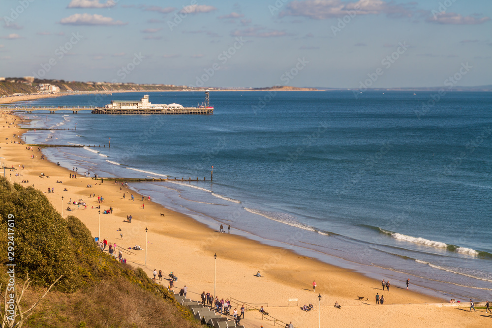 Golden beach and pier in distance, seafront at Bournemouth.
