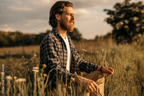 Bearded guy establishing connection with nature