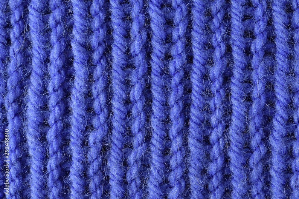 Blue wool yarn knitted texture with large stitches. Hand knitted ribbing stitch pattern. Closeup