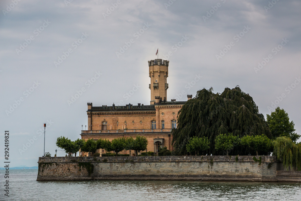 Little castle with round tower near the lake