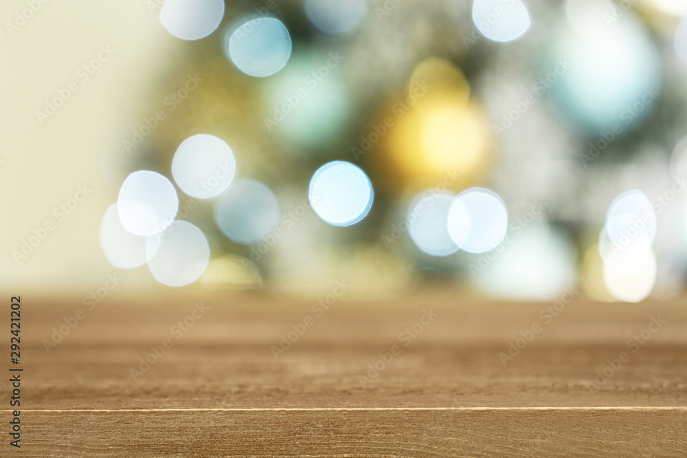 Empty wooden table and blurred fir tree with Christmas lights on background, bokeh effect. Space for design Empty wooden table and blurred fir tree with Christmas lights on background, bokeh effect. Space for design