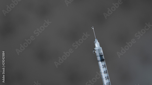 drops of medicine are sprayed out of the syringe