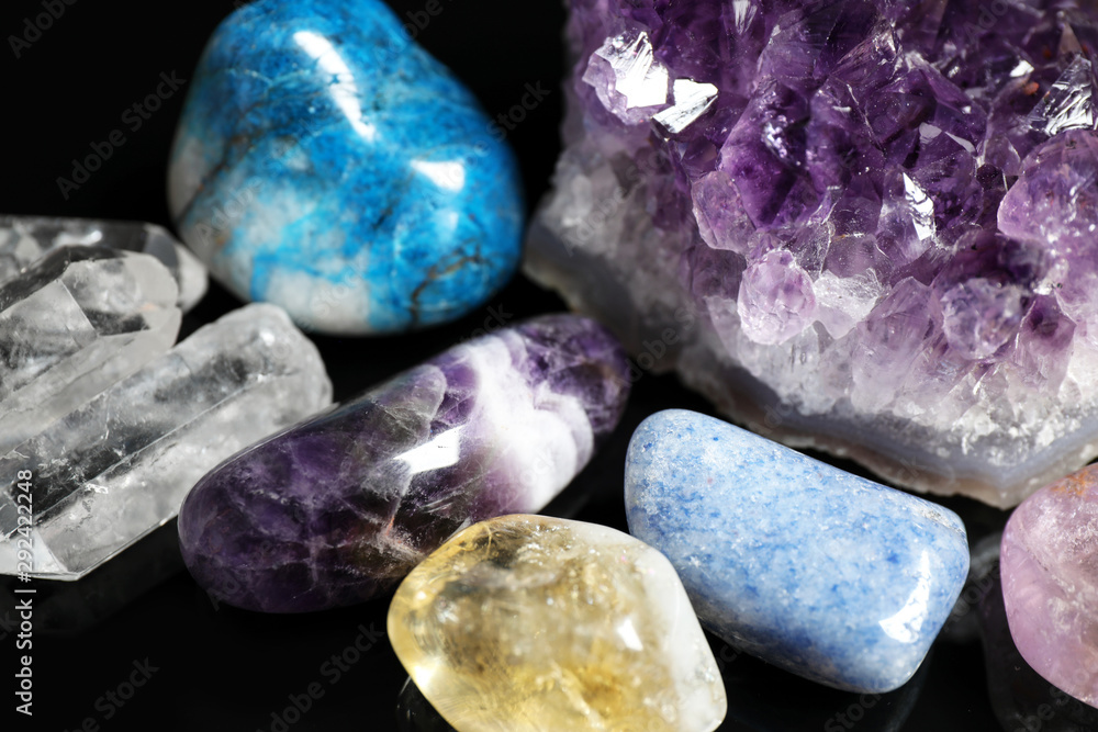 Different beautiful gemstones on black background, closeup Different beautiful gemstones on black background, closeup