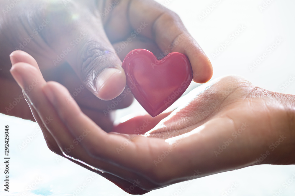 Male Hand Giving Heart To Female Male Hand Giving Heart To Female