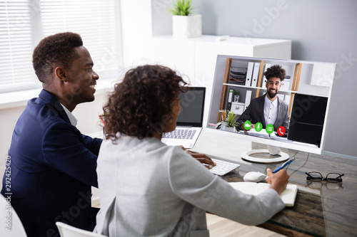 Businesspeople Videoconferencing With Colleague