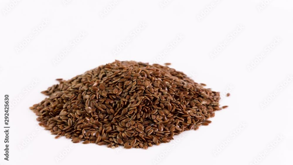Rotation flax seeds on white background. Rotation flax seeds on white background.