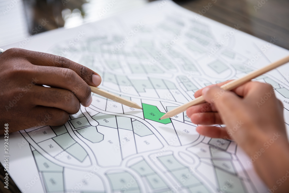 Hands Holding Pencils Over Cadastre Map Hands Holding Pencils Over Cadastre Map