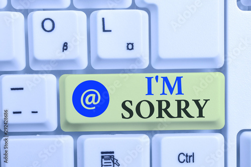 Writing note showing I M Sorry. Business concept for Toask for forgiveness to someone you unintensionaly hurt White pc keyboard with note paper above the white background photo