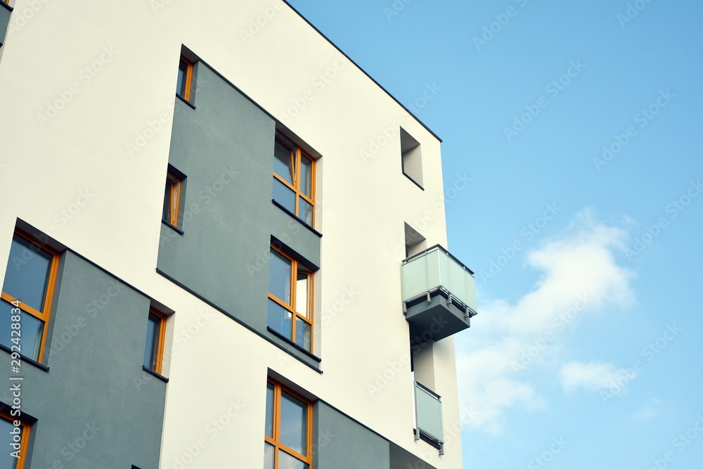Modern apartment buildings on a sunny day with a blue sky. Facade of a modern apartment building Modern apartment buildings on a sunny day with a blue sky. Facade of a modern apartment building