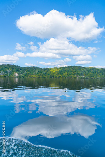 Reflected lake edge and white clouds © Brian Scantlebury