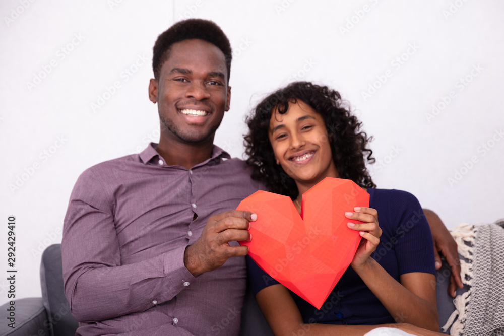 Romantic Couple Holding A Red Heart