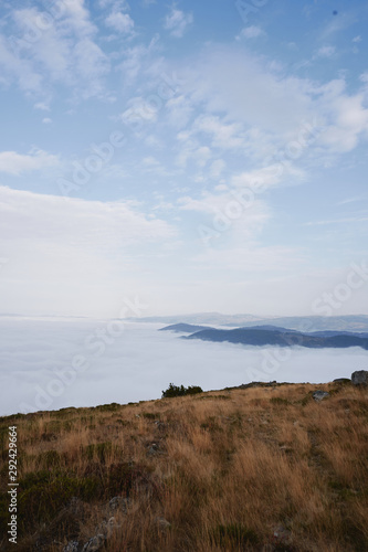 Morning with mist in the mountains. Hight point view. Scenic fog and blue sky with clouds. Portrait frame. Portugal photo