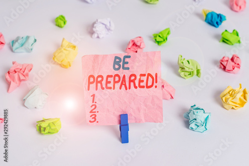 Conceptual hand writing showing Be Prepared. Concept meaning try be always ready to do or deal with something Colored crumpled paper empty reminder white floor clothespin