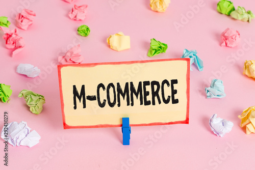 Conceptual hand writing showing M Commerce. Concept meaning commercial transactions conducted electronically by mobile phone Colored crumpled papers empty reminder pink floor clothespin photo