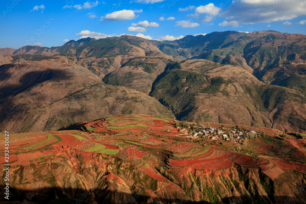 Dongchuan Red Earth Multi-Colored Terraces - Red Soil, Green Grass, Layered Terraces in Yunnan Province, China. Chinese Countryside, Agriculture, Exotic Unique Landscape. Farmland, Agriculture