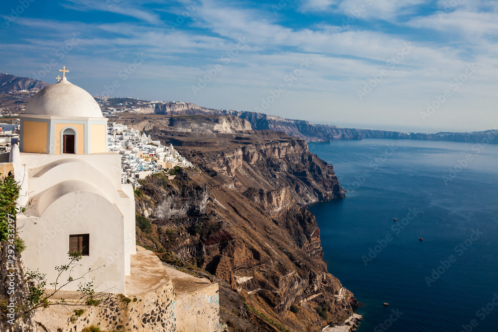 The Aegean sea and the Catholic Church of St. Stylianos in the city of Fira in Santorini Island