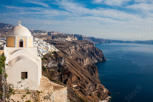 The Aegean sea and the Catholic Church of St. Stylianos in the city of Fira in Santorini Island