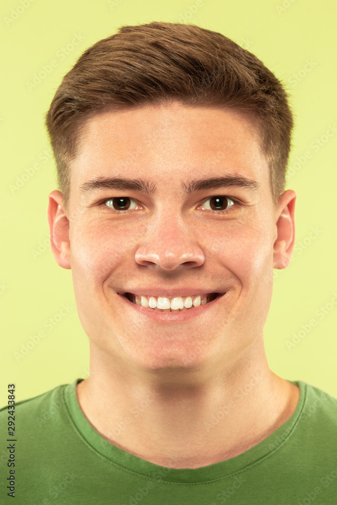 Caucasian young man's close up shot on studio background. Beautiful male model with well-kept skin. Concept of human emotions, facial expression, sales, ad. Copyspace. Smiling, looking at camera. Caucasian young man's close up shot on studio background. Beautiful male model with well-kept skin. Concept of human emotions, facial expression, sales, ad. Copyspace. Smiling, looking at camera.