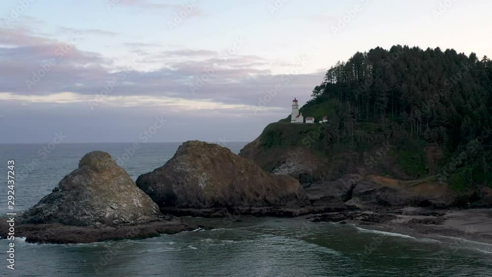 Aerial drone cinematic flying at sunrise at Heceta head lighthouse in Oregon Aerial drone cinematic flying at sunrise at Heceta head lighthouse in Oregon