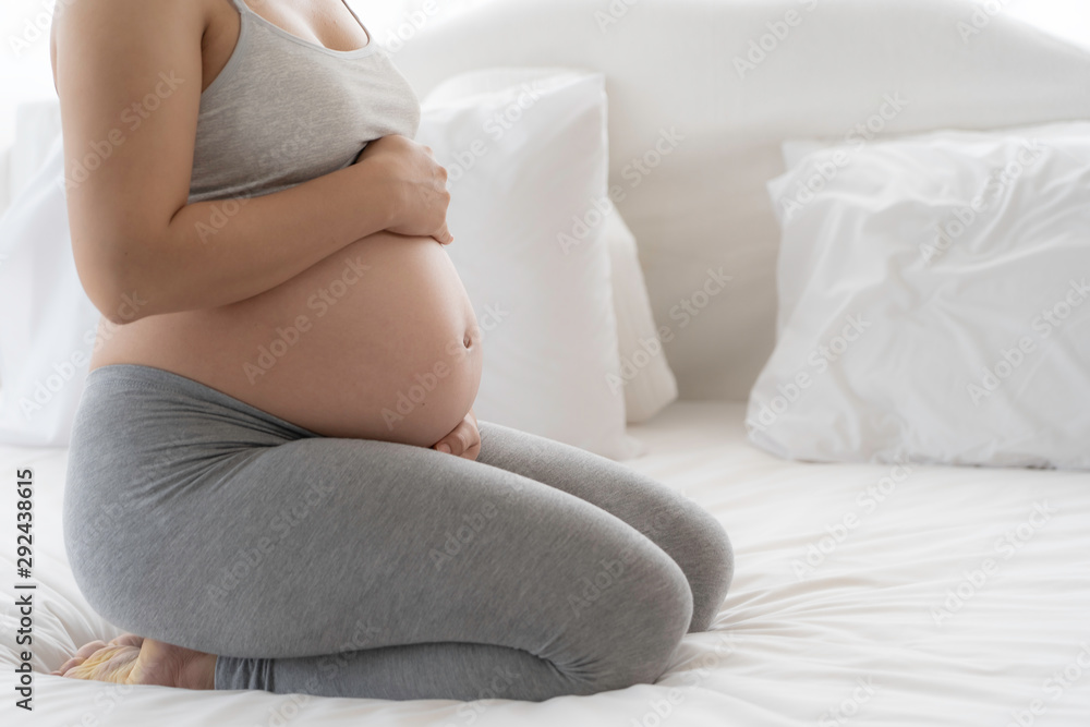 Happy Beautiful Asian pregnant on bed Happy Beautiful Asian pregnant on bed
