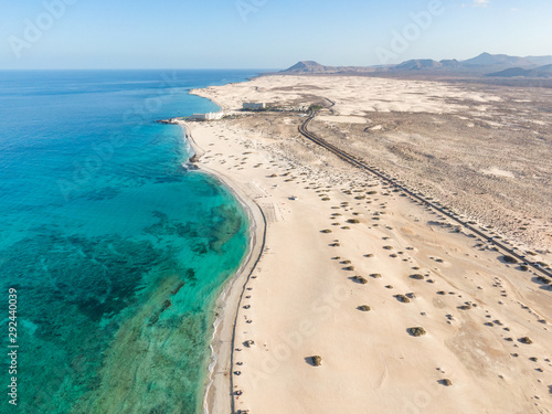Panoramic high angle aerial drone view of Corralejo National Park (Parque Natural de Corralejo) with sand dunes located in the northeast corner of the island of Fuerteventura, Canary Islands, Spain. photo