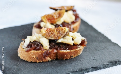 a bruschetta sandwich with onion confiture and cream Camembert cheese on a slice of ciabatta bread