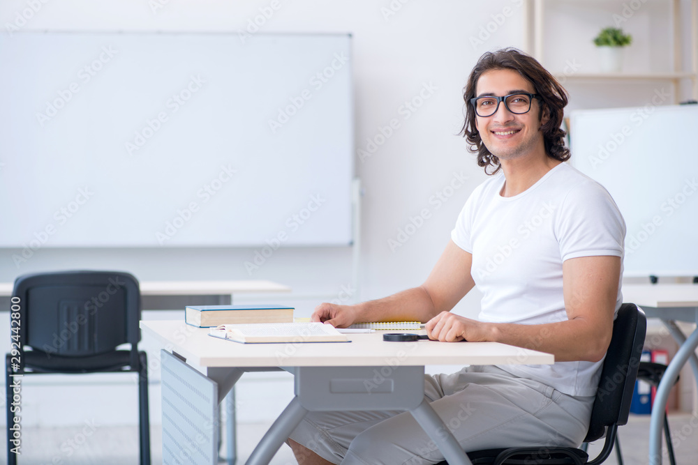 Young male student in front of whiteboard Young male student in front of whiteboard