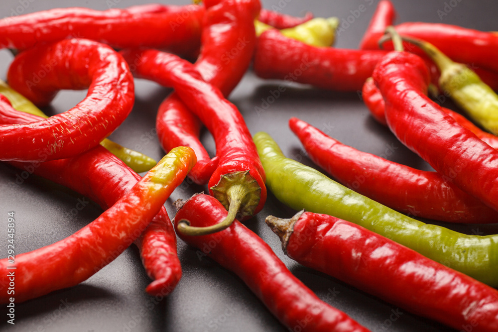 many different peppers on black table, selective focus macro photo many different peppers on black table, selective focus macro photo