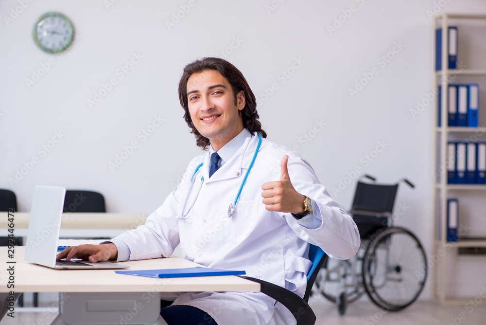 Young handsome doctor in telemedicine concept Young handsome doctor in telemedicine concept