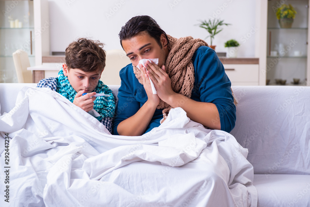 Young father caring for sick son Young father caring for sick son