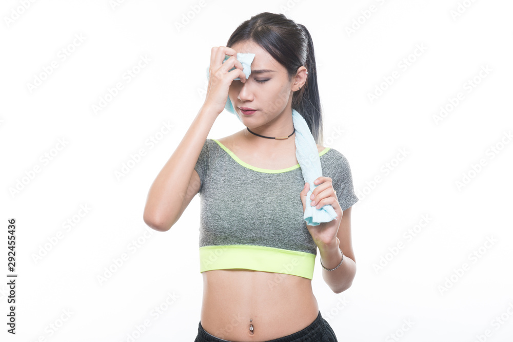 charming young girl in sports is smiling looks right and handling a towel, Healthy concept, Studio light portrait. charming young girl in sports is smiling looks right and handling a towel, Healthy concept, Studio light portrait.