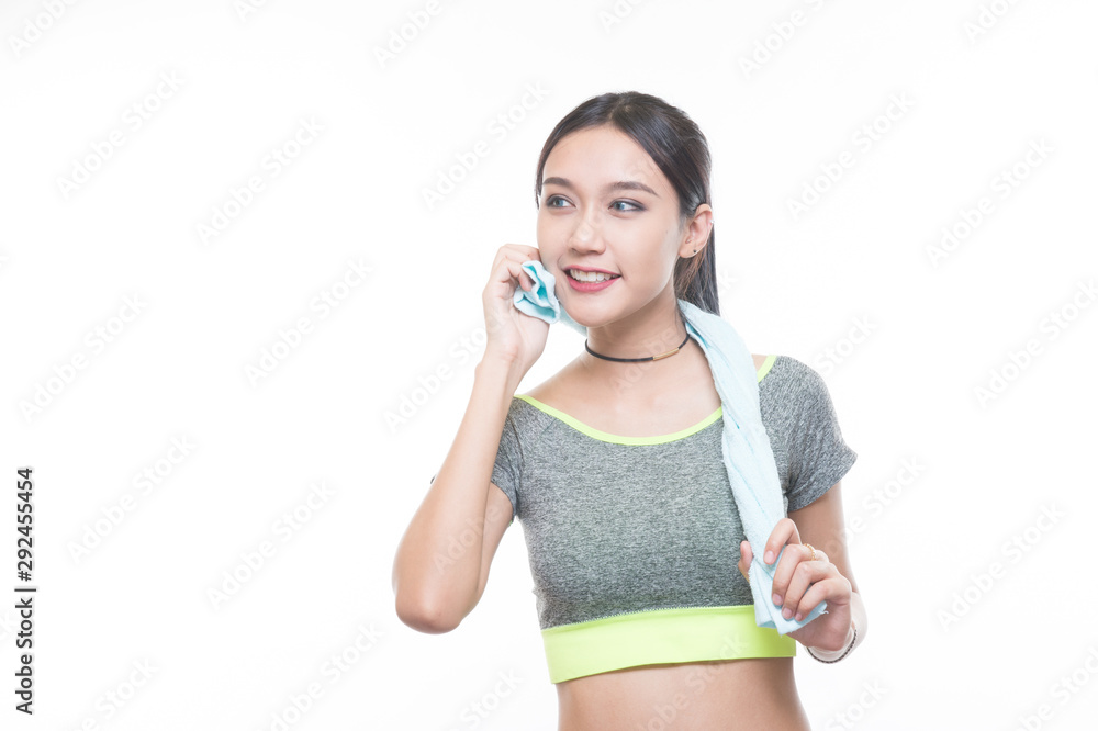 charming young girl in sports is smiling looks right and handling a towel, Healthy concept, Studio light portrait. charming young girl in sports is smiling looks right and handling a towel, Healthy concept, Studio light portrait.