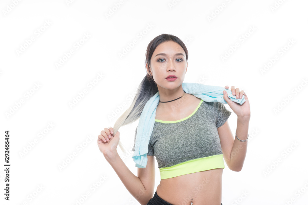 charming young girl in sports is smiling looks right and handling a towel, Healthy concept, Studio light portrait. charming young girl in sports is smiling looks right and handling a towel, Healthy concept, Studio light portrait.
