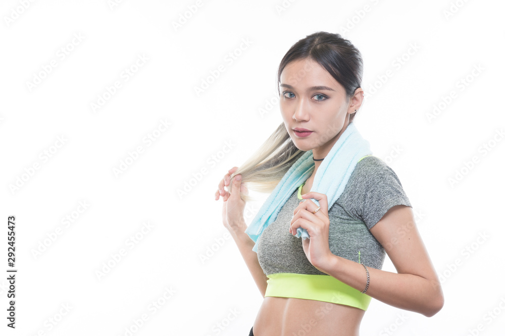 charming young girl in sports is smiling looks right and handling a towel, Healthy concept, Studio light portrait. charming young girl in sports is smiling looks right and handling a towel, Healthy concept, Studio light portrait.