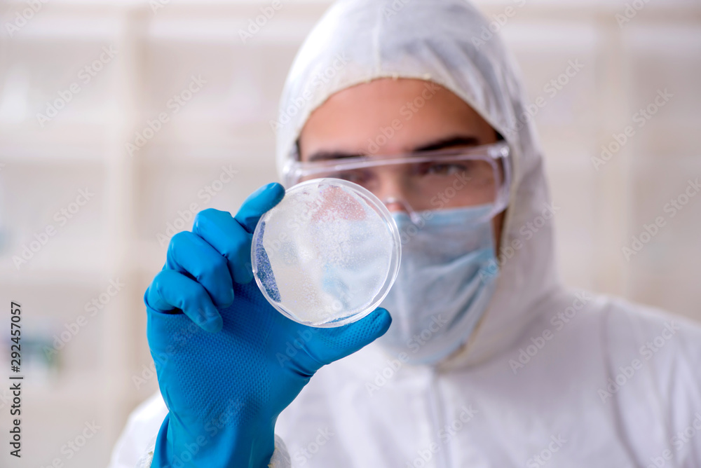 Young male chemist working in the lab Young male chemist working in the lab